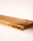 Floating antique style shelf made from scaffold wood showing lots of character