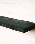 Blue coloured floating radiator shelf made from real wood