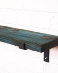 Wooden radiator shelf with blue dye and propped metal brackets leaving a dramatic effect