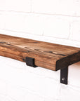 Shou Sugi Ban effect radiator shelf to showcase the grain pattern of the wood with brackets that are propped