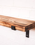 Propped wooden radiator shelf with a flamed look