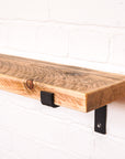 Natural looking timber radiator shelf with propped metal brackets