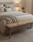 Bedroom with a wooden bench at the foot of the bed