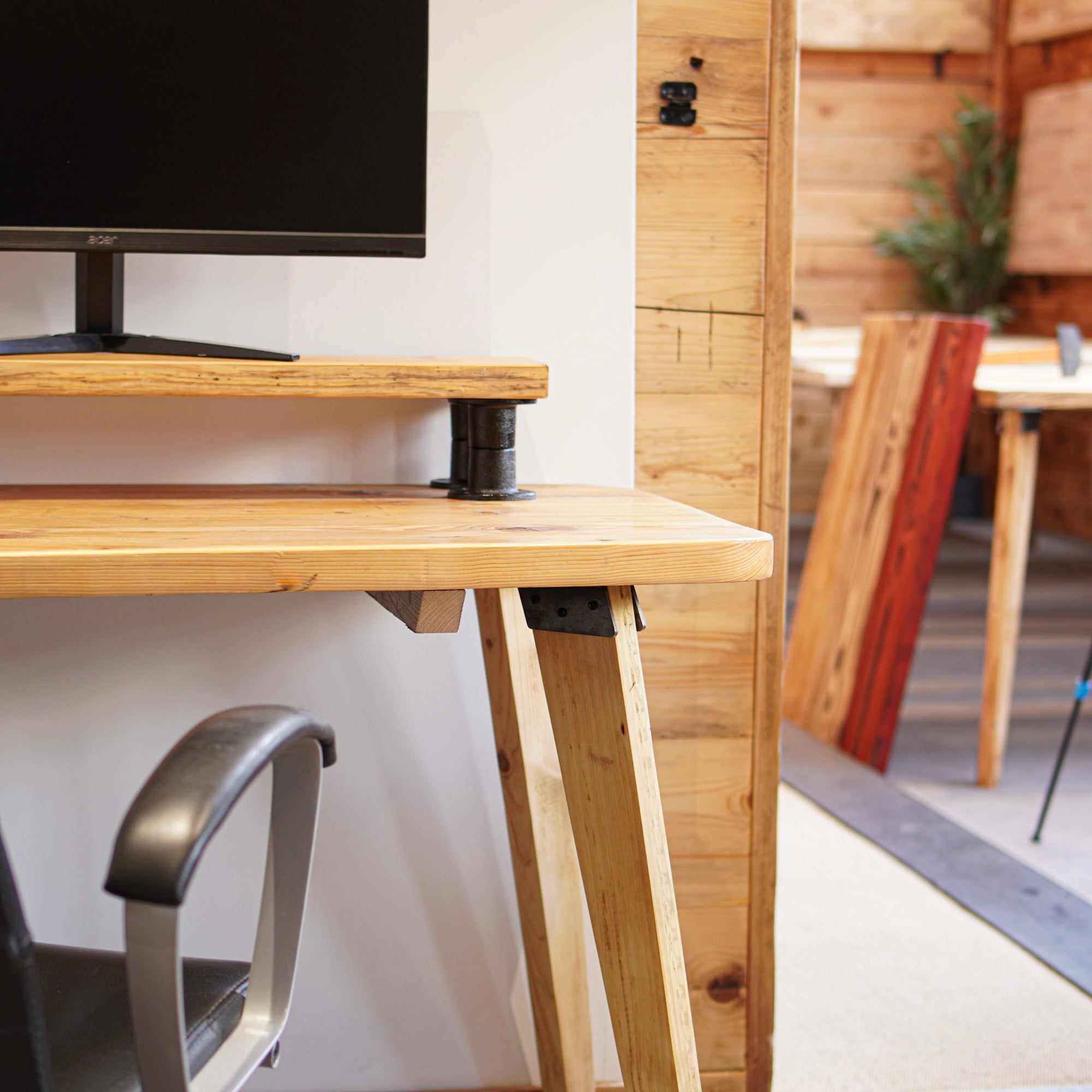 Monitor stand on a wooden desk