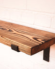 Charred effect shelf with metal brackets
