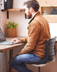 Wooden corner desk made from reclaimed wood situated in an open office space