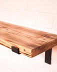 Flamed shelf from natural wood