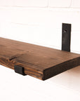 Dark oak shelf with metal brackets