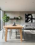 Modern living room with wooden dining table and gray sofa