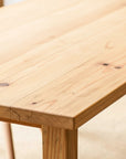 Close-up of a wooden table with visible grain and texture. sanded with natural oil