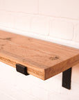 Scaff board shelf with metal propped bracket