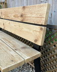 Outside wooden bench with black metal legs