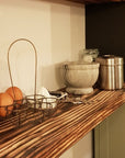 Charred scaffold board used as shelf in kitchen
