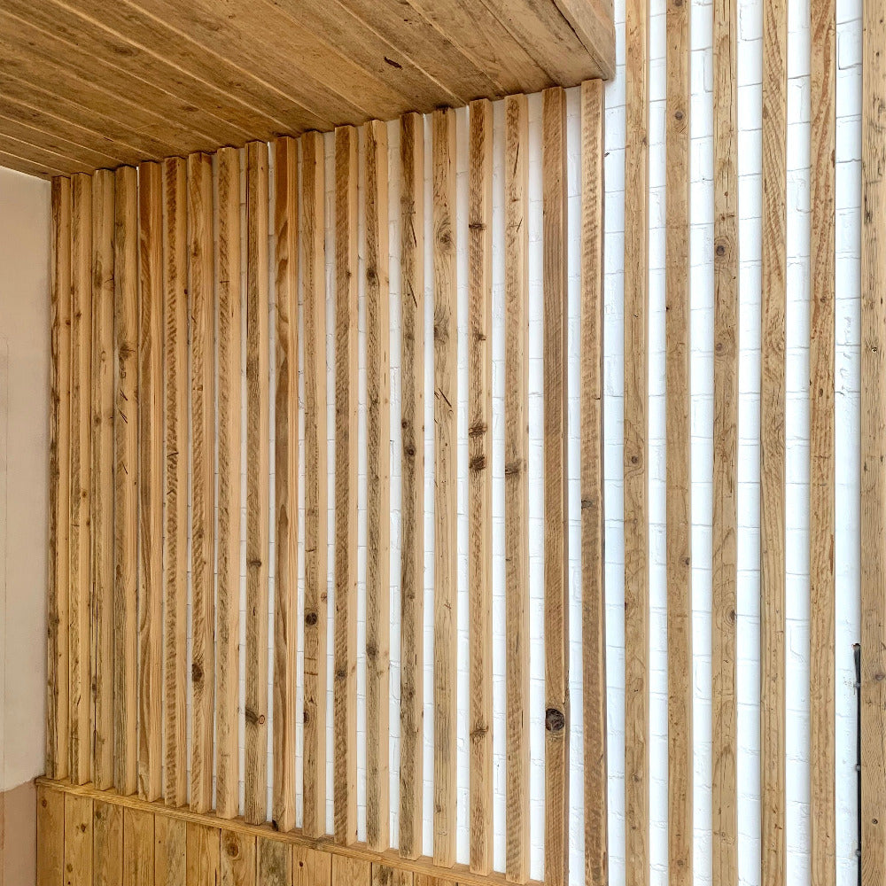 Scaffold board battens oiled and sanded, cladded on to wall