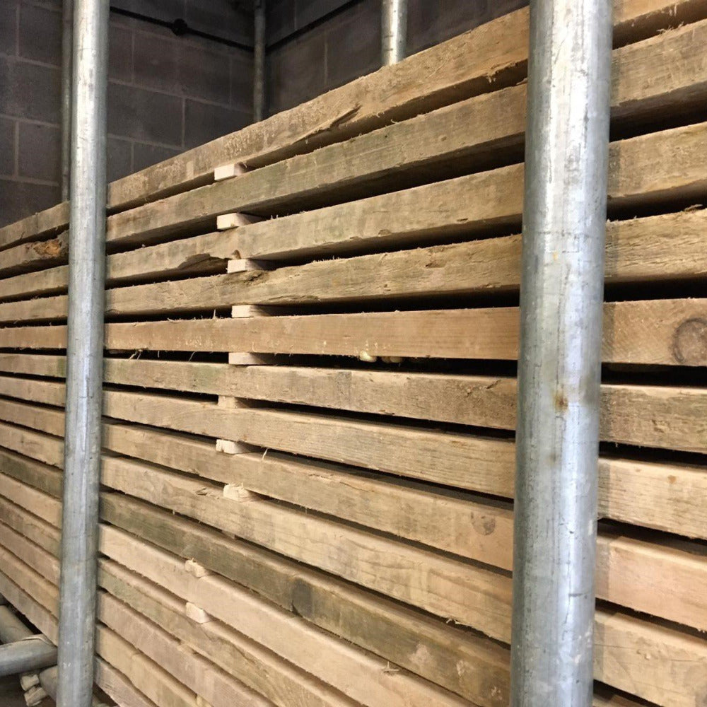 Scaffold boards stached up on bearers at The Scaff Shop