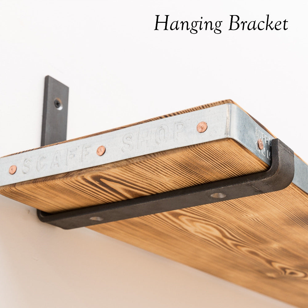 Reclaimed scaffold board shelf hanging off of a steel bracket