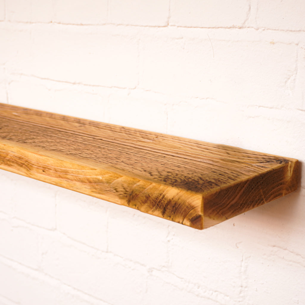 Floating antique style shelf made from scaffold wood showing lots of character