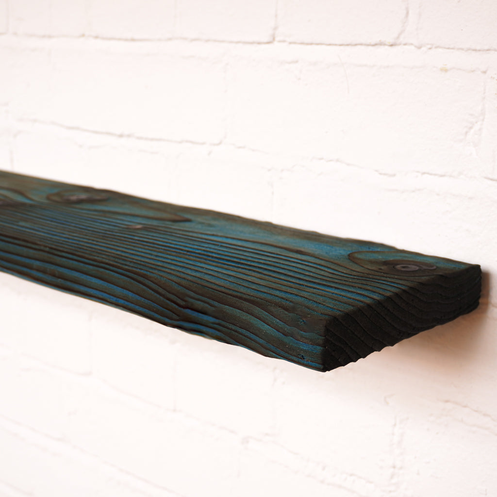 Blue coloured floating radiator shelf made from real wood