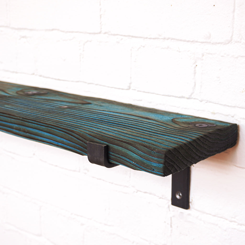 Wooden radiator shelf with blue dye and propped metal brackets leaving a dramatic effect