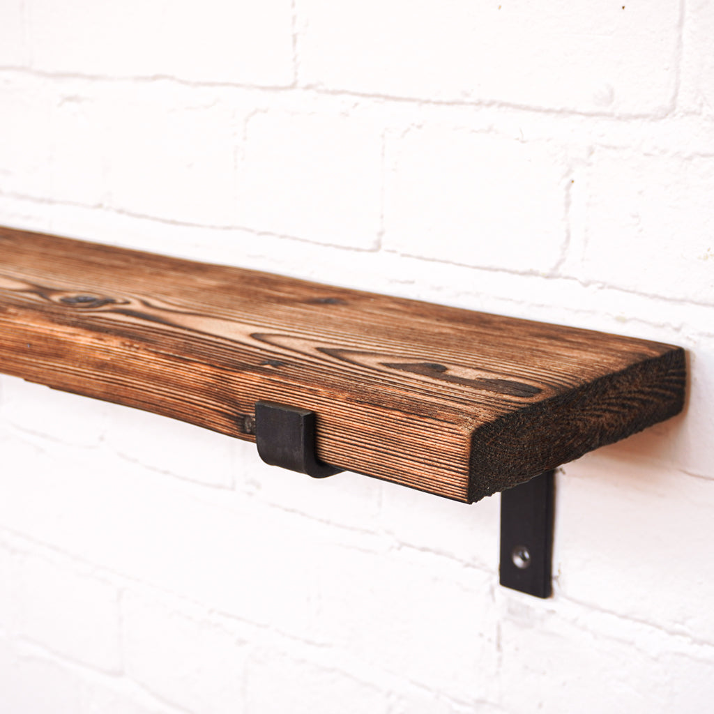 Shou Sugi Ban effect radiator shelf to showcase the grain pattern of the wood with brackets that are propped