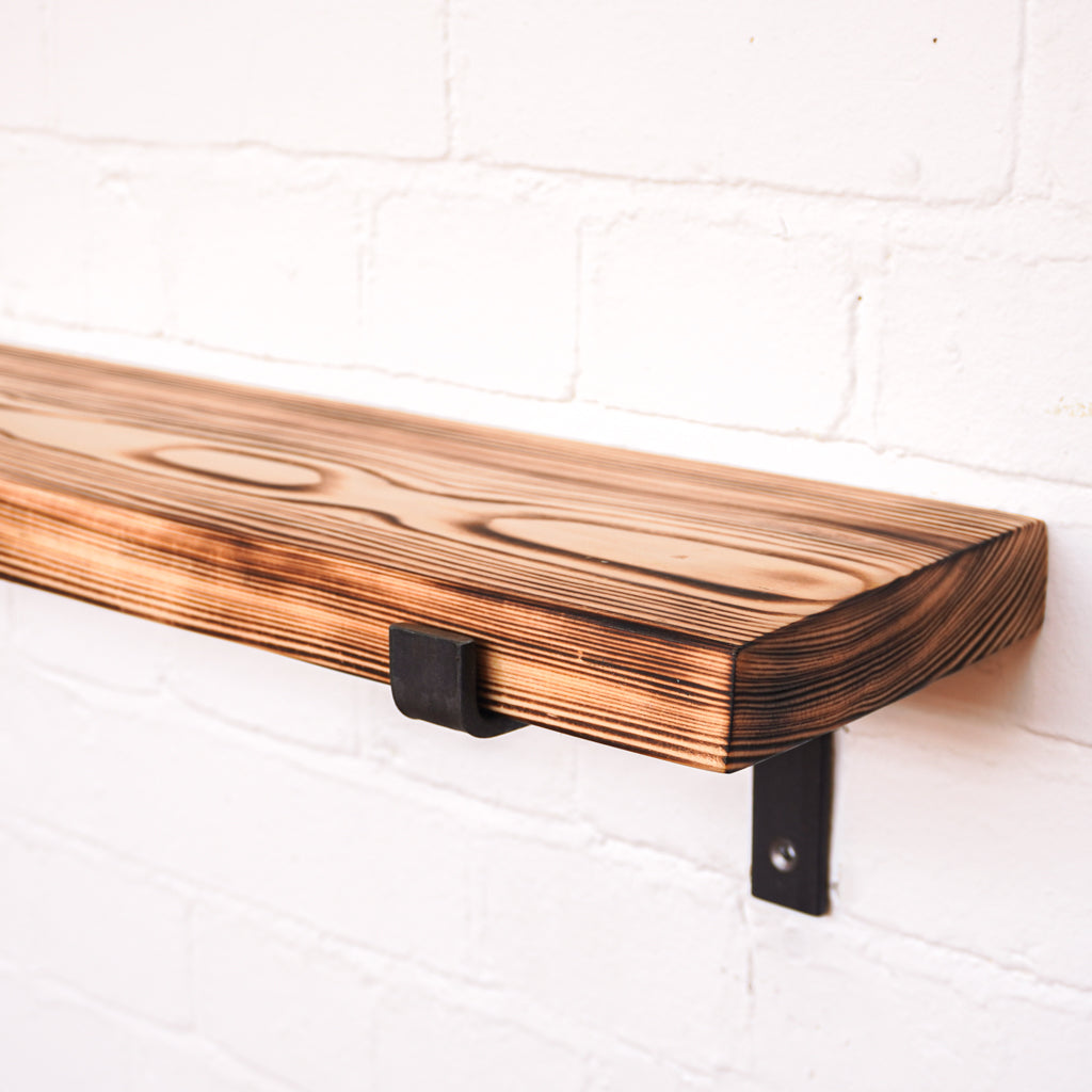 Propped wooden radiator shelf with a flamed look
