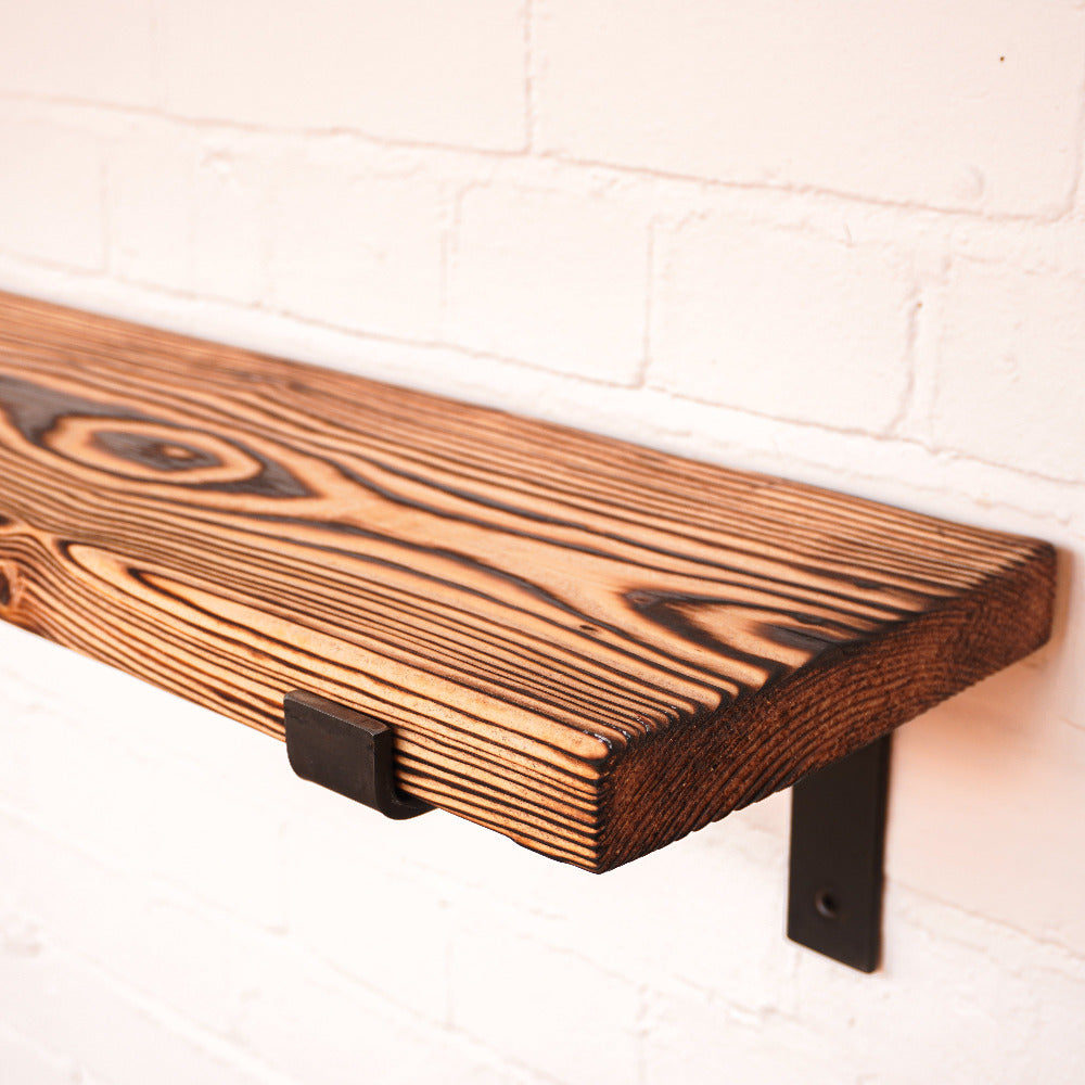 Charred effect shelf with metal brackets