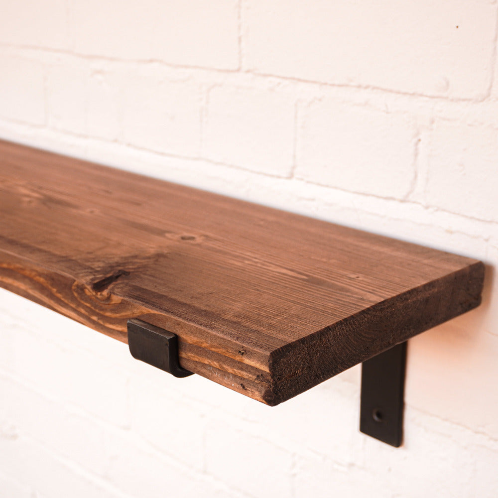 Dark wood shelf with metal brackets