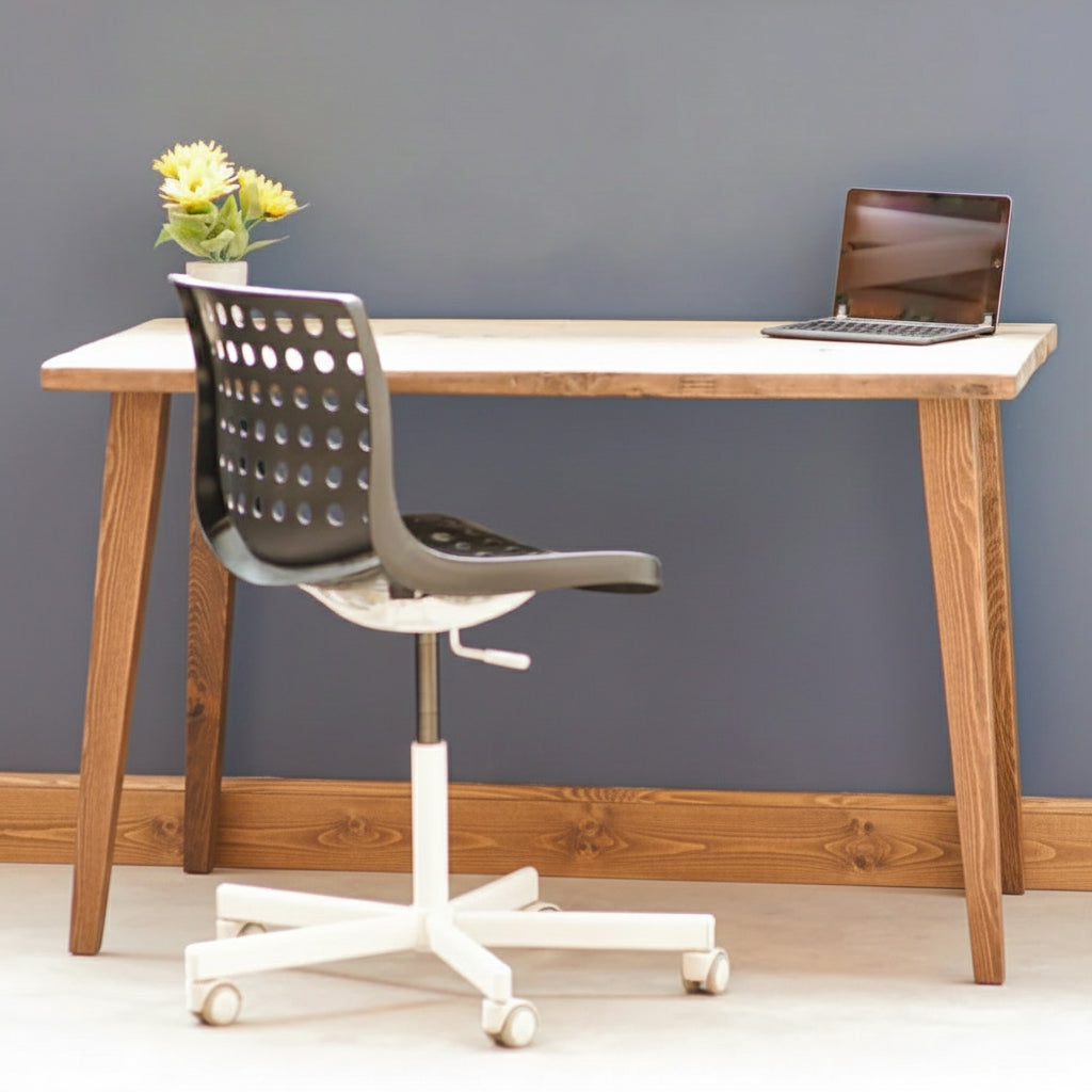 Wooden desk with a chair and laptop against a gray wall