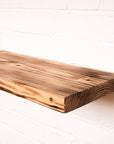 Reclaimed scaffold board in lightly flamed finish with floating brackets