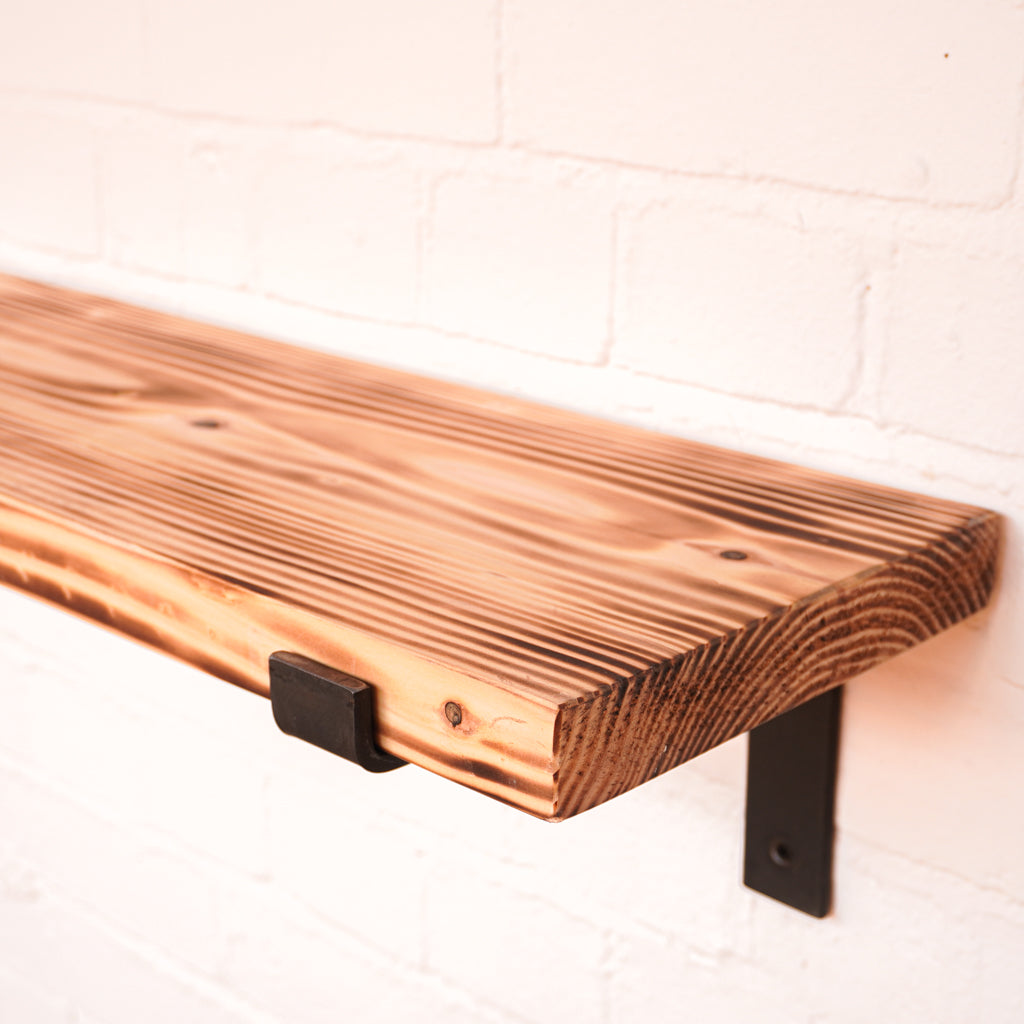 Flamed shelf from natural wood