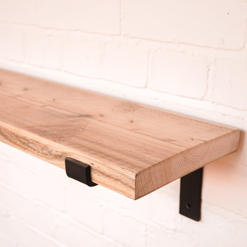 Hand sanded scaffold board shelf with propped metal brackets