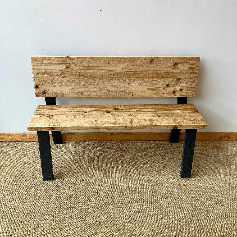 Pale wooden boards with black metal legs to make a bench