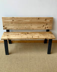 Pale wooden boards with black metal legs to make a bench