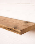 Reclaimed Sanded scaffold board with a natural finish as a shelf with a floating bracket