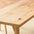 Close-up of a wooden table with visible grain and texture. No oil finish