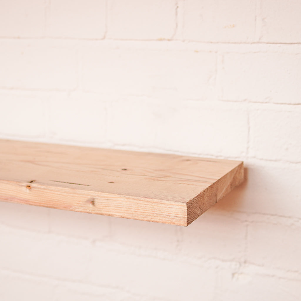 Planed Scaffolding Board shelf against a white brick wall
