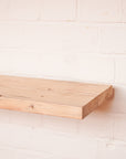 Planed Scaffolding Board shelf against a white brick wall
