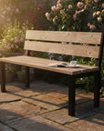 Outdoor Wooden bench on a patio with flowers in the background