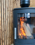 Stunning visual of a woodburner in front of scaffold board cladding from The Scaff Shop
