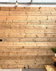 Scaffold boards suspended on a wall to make a timber screen