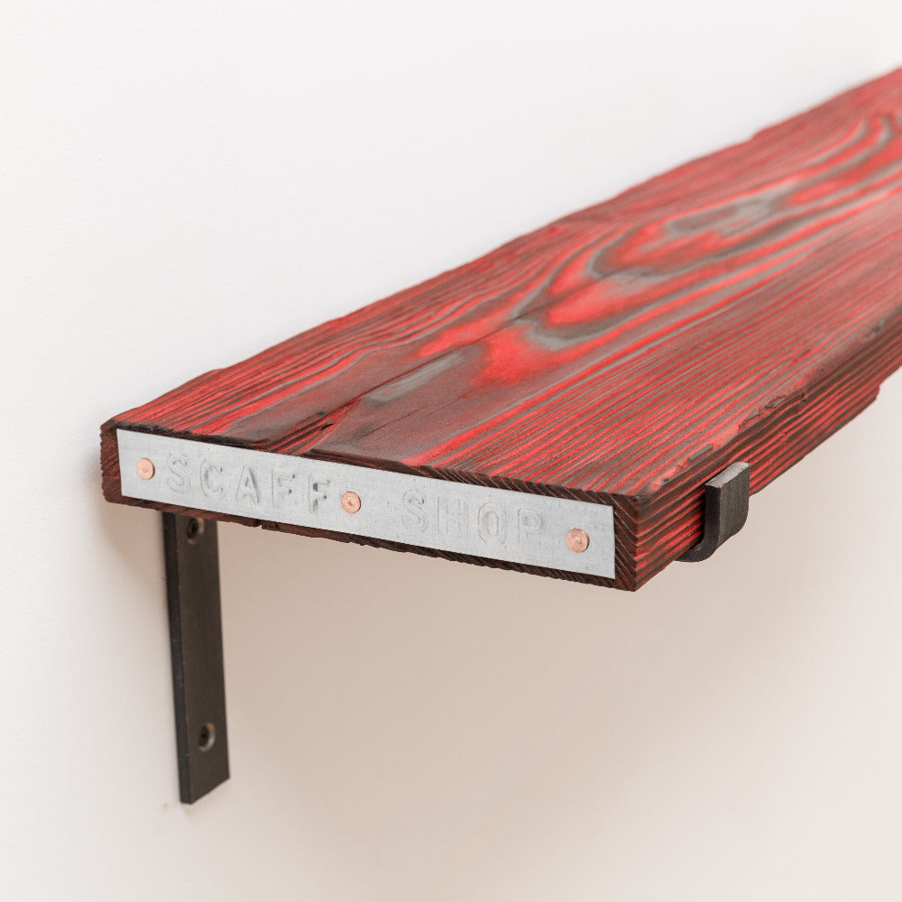 Red dyed wooden shelf made from reclaimed and sustainable scaffold boards