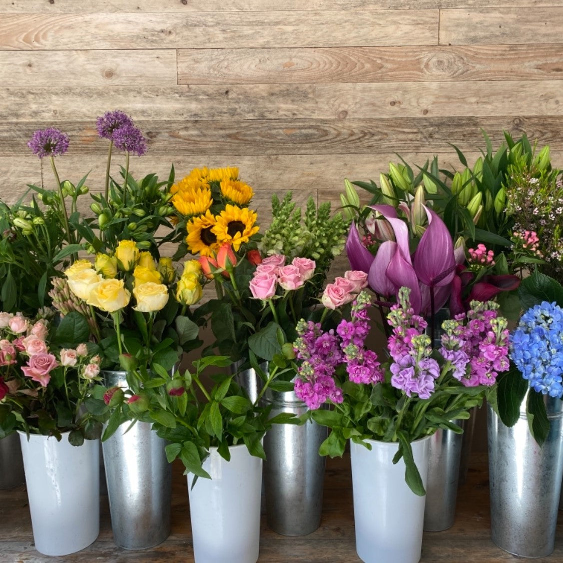 Pallet wood cladding behind flower display